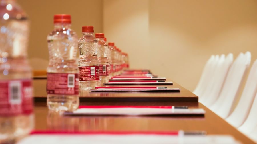 A conference table neatly set with water bottles and stationery, prepared for a productive meeting at Shilton Dee Cee.