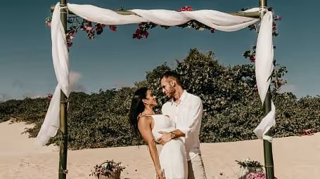 A couple posing for a photo at a beach