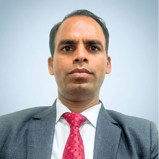 Corporate Executive Housekeeper in suit and tie at Pride Hotels Group.