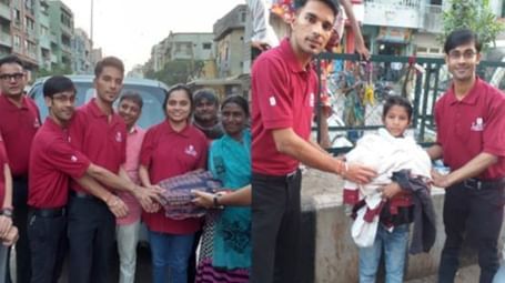 A group of people in red and white shirts are posing with a signed certificate - Lords Hotels & Resorts