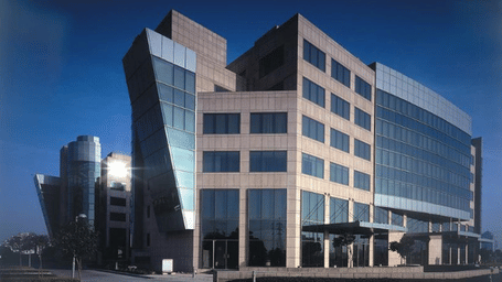 Modern glass and concrete corporate office building architecture in Gurgaon, Haryana.
