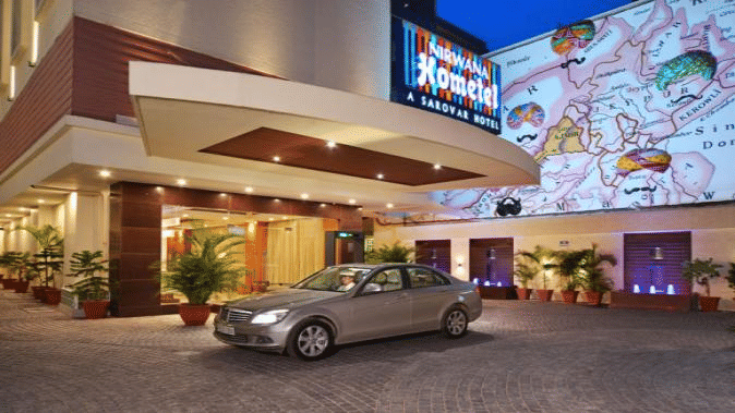Facade Nirwana Hometel Jaipur, with a car parked in the parking space.