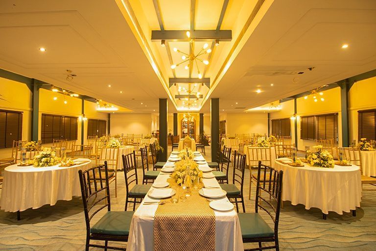 Indoor banquet area at Polo Floatel Kolkata with round tables, white tablecloths, and warm ceiling lights.