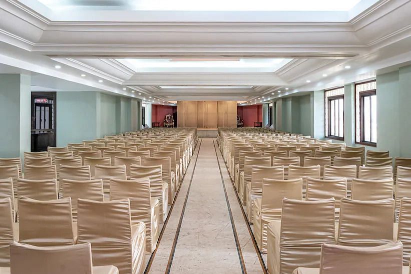 Back view of Banquet Hall with multiple chairs and modern interior - Hotel Ram International, Pondicherry