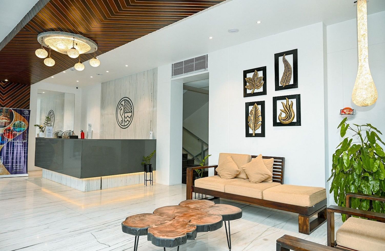 A chic hotel reception with modern furniture, decorative lighting, and wall art - Sea Hills Hotels, Sri Vijayapuram (Port Blair)