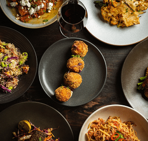 An image of a different delicacies presented on plates laid out on a table