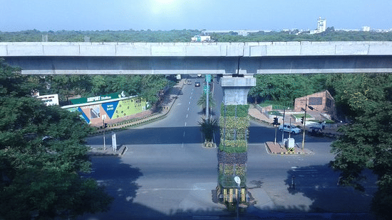 Aerial view of a city flyover with surrounding greenery and roadway at The Pride Premier Nagpur.