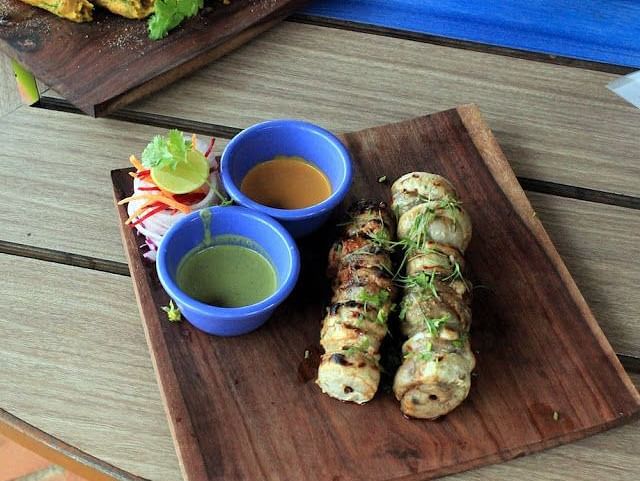 An image of an Indian tandoor dish served on a wooden platter