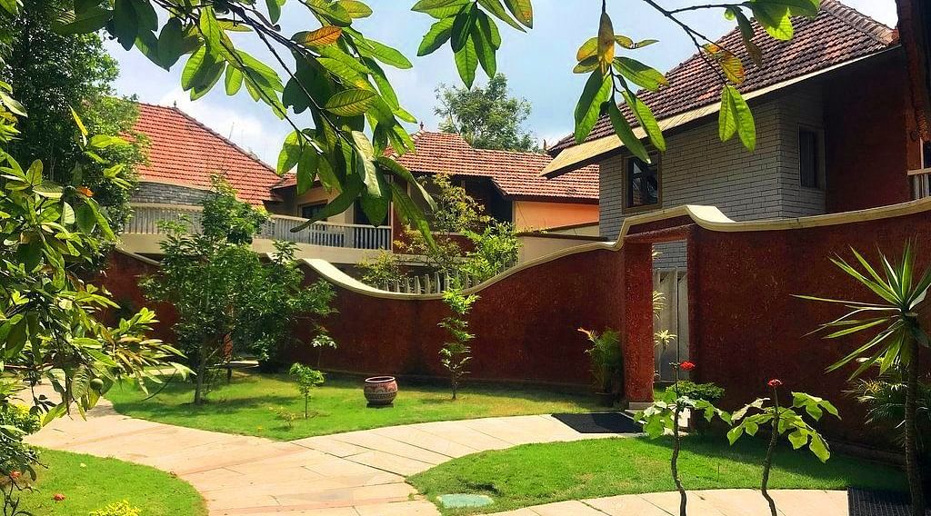facade image of the luxury jucuzzi villas nestled amidst lush greenery at hoysala village resort in hassan
