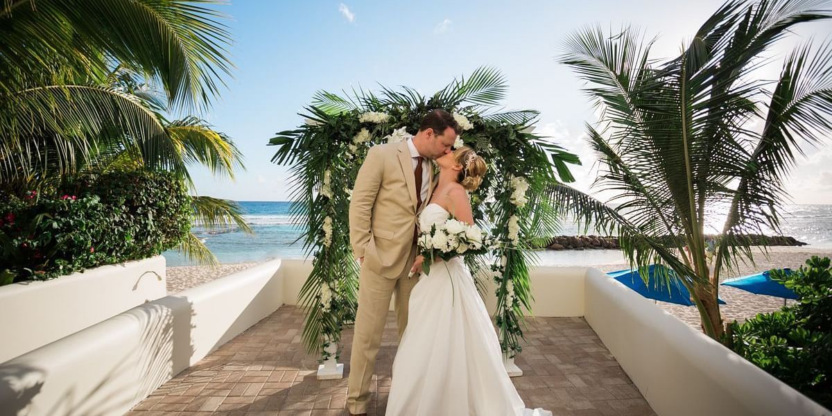 A newly wed couple kissing - The Soco Hotel Barbados