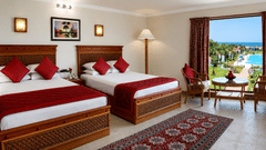 Ocean View Room with twin beds, a private balcony, and beautiful views of the pool and sea at Chariot Beach Resorts, offering a scenic retreat