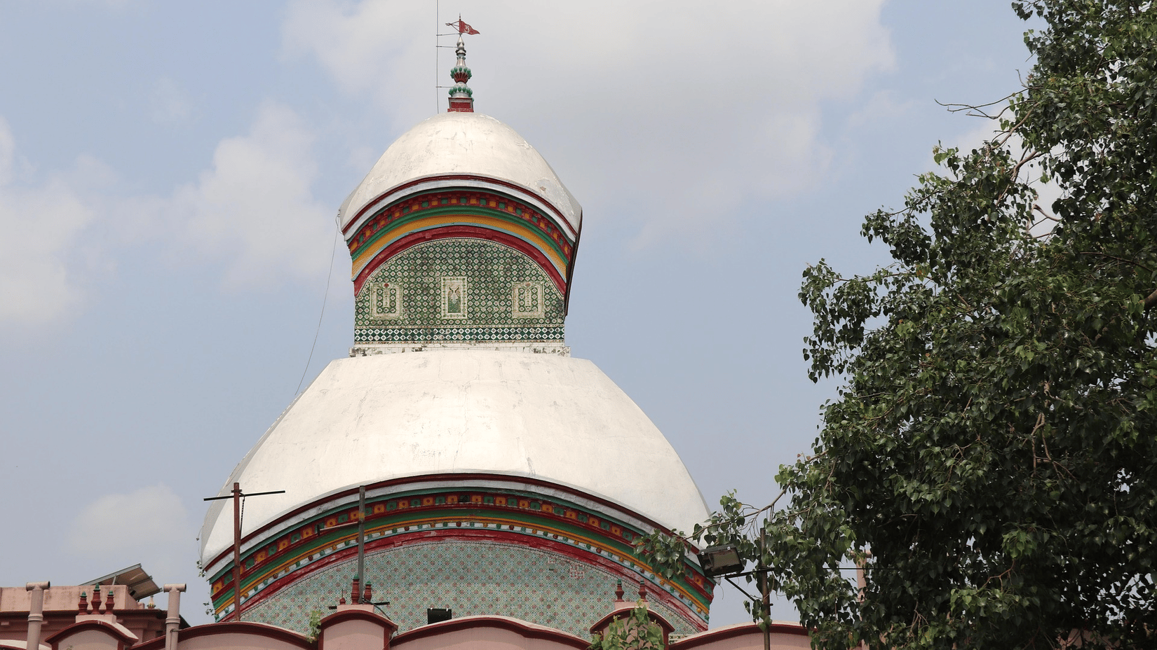 Kalighat Kali Maa Temple featuring subtle green accents set against a cloudy light sky