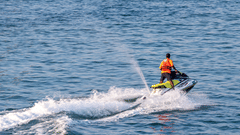 A person jet skiing on the beach