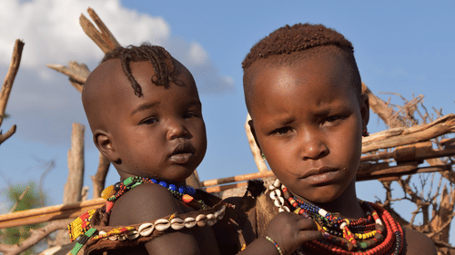 Children of a tribal community wearing colourful ornaments