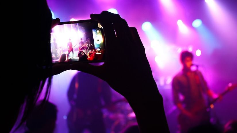 A closeup shot from a phone of a performance on stage