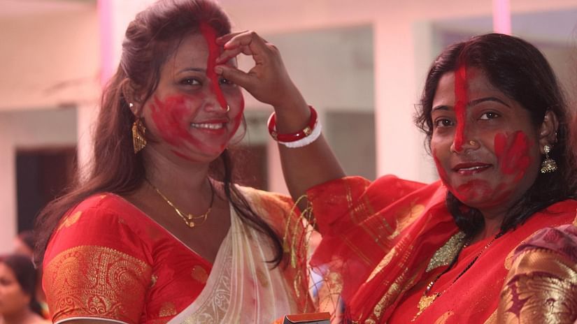 Women applying sindoor on each other on Durga Puja
