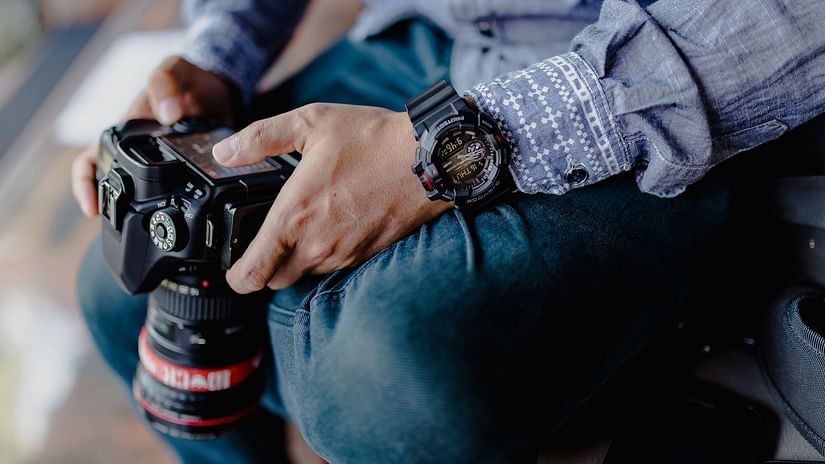 A man holding a DSLR camera
