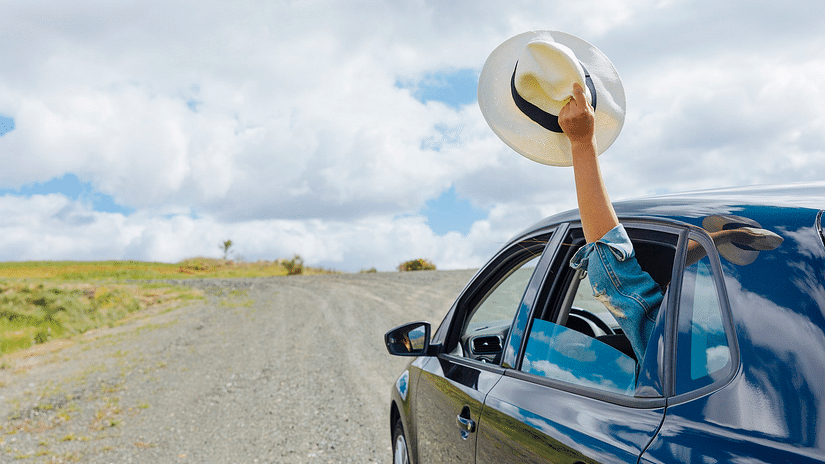 A car driving in empty roads under clear skies