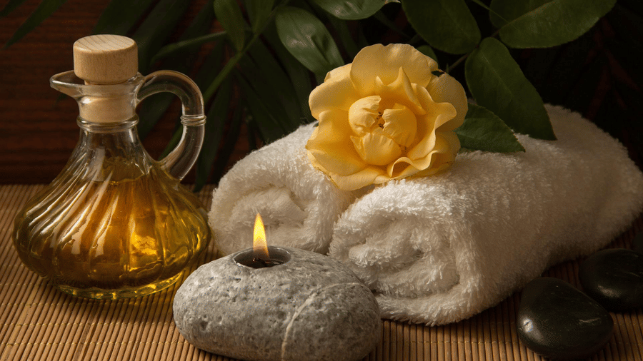 therapy oil, towels and hot stones kept for a spa service