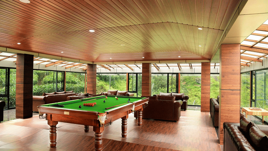 Shot of a billiard table at the hall of the villa Shot of the balcony at the villa with chairs kept | Ibex Stays and Trails, Valparai (Tale Rock)