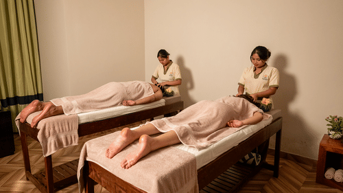 Two people receiving massages in a twin spa room at Silver Sand Beach Resort, Havelock.