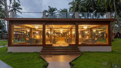 Glass-front restaurant with warm lighting at Silver Sand Sea Princess Beach Resort, Port Blair.
