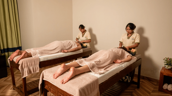 Two people receiving massages in a twin spa room at Silver Sand Beach Resort, Havelock.