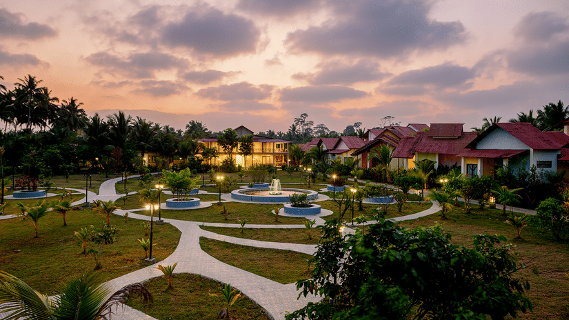 Tropical resort at sunset with fountains at Silver Sand Village Resort, Havelock