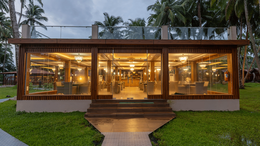 Glass-front restaurant with warm lighting at Silver Sand Sea Princess Beach Resort, Port Blair.