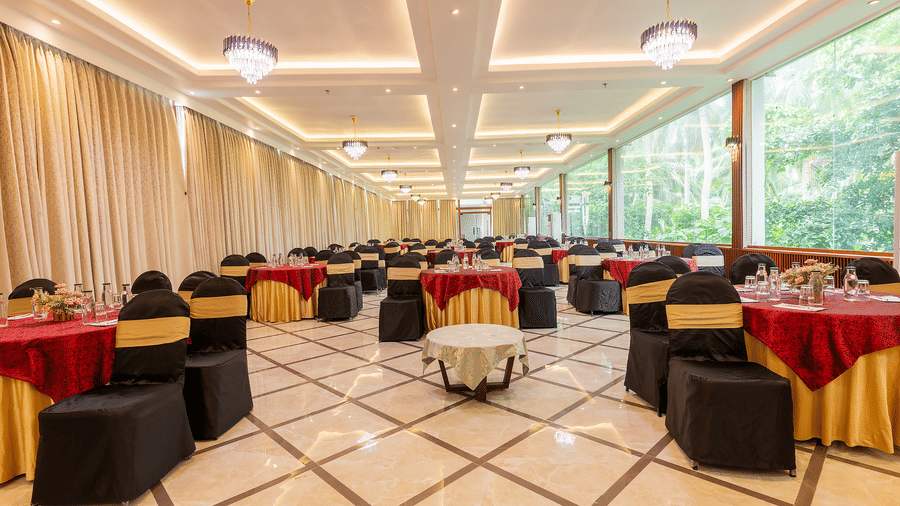 Dining area with round tables and bright interiors at Silver Sand Sea Princess Beach Resort, Port Blair.