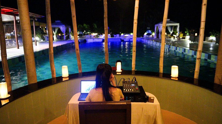 DJ booth by pool at night at Silver Sand Village Resort, Havelock