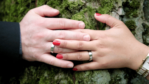 newlyweds showing off their rings