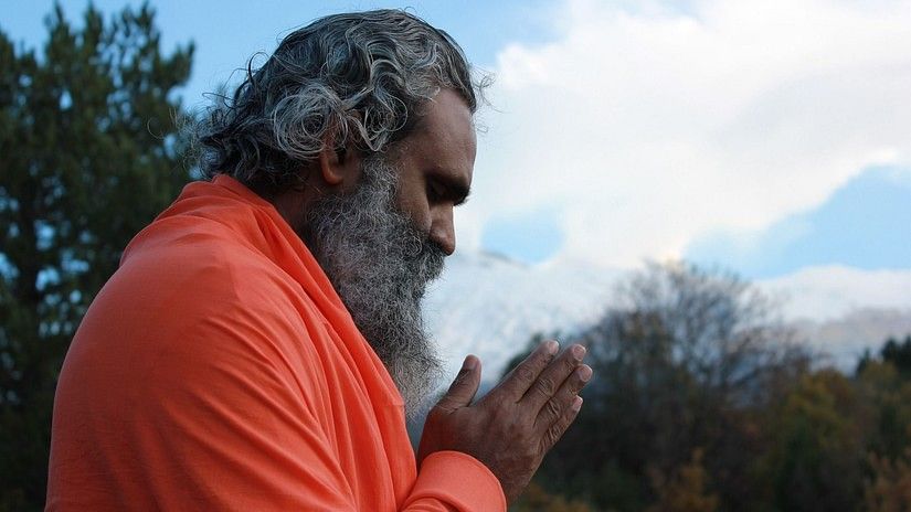 A man praying with hands folded