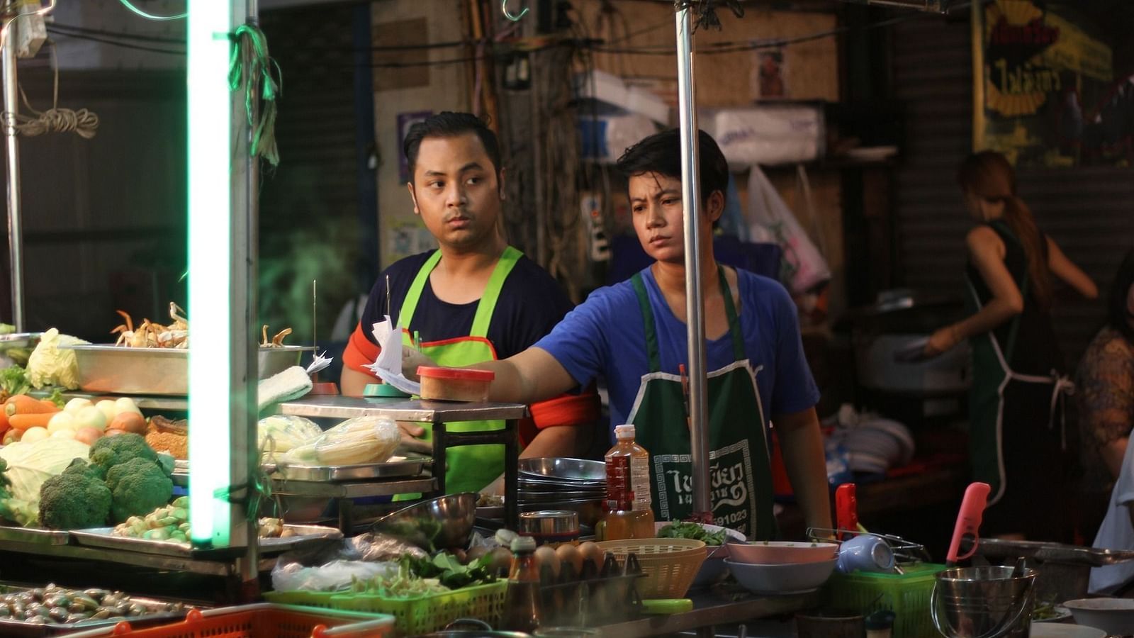 street vendors in china town looking away from the camera and working