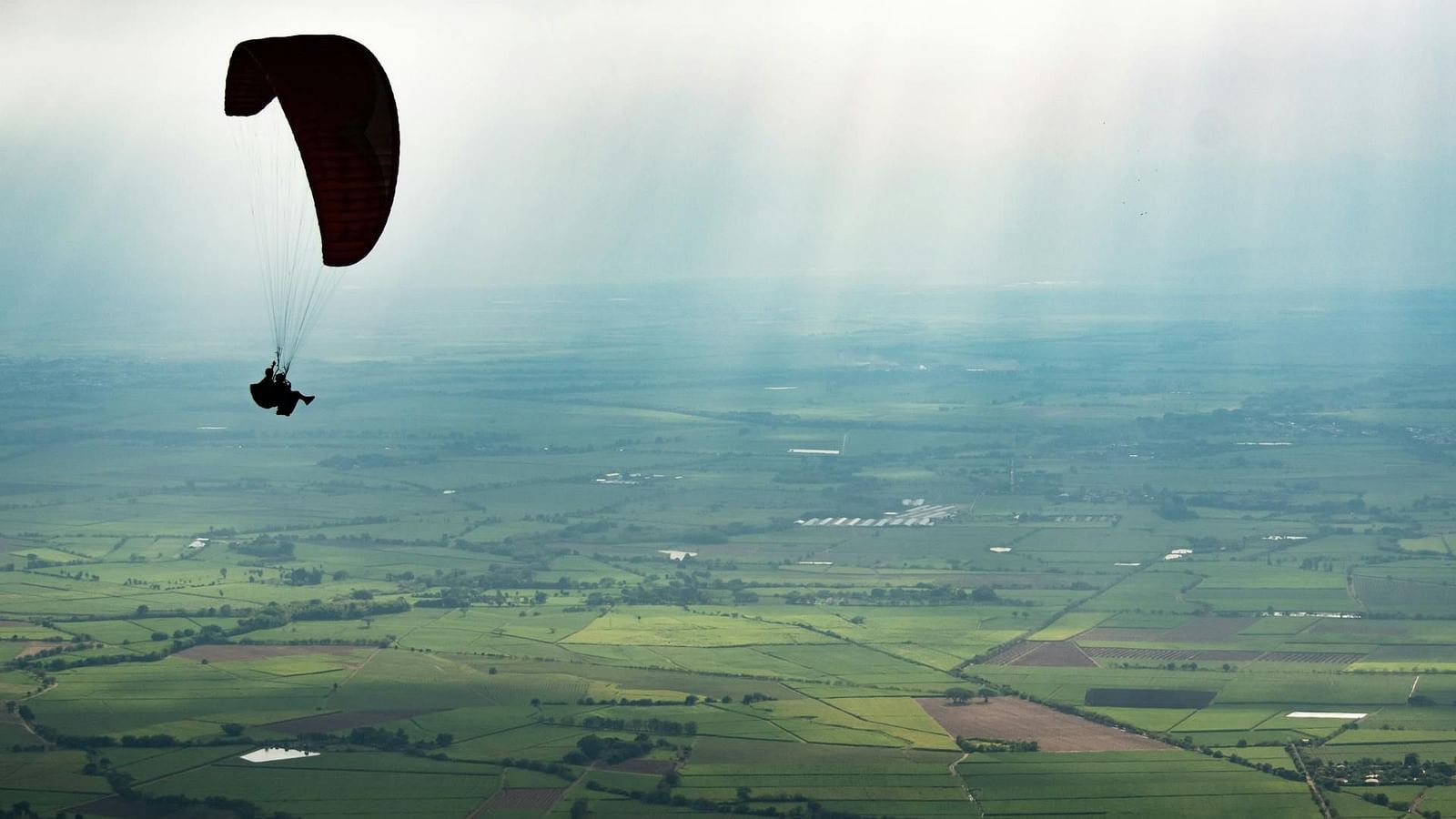 an image of a person performing paragliding