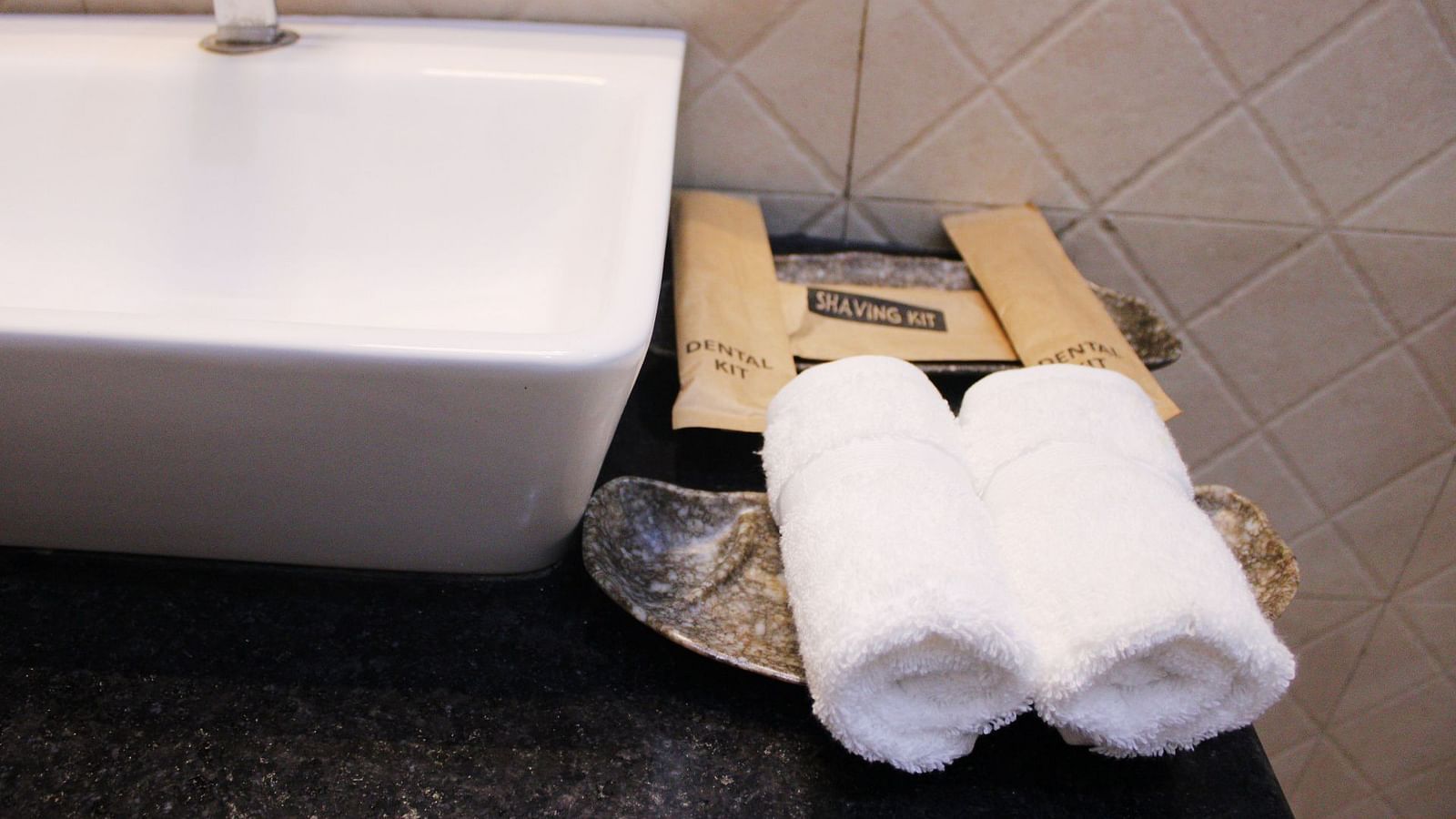 Toiletries placed next to a sink of a Deluxe Cottage Room at Royale Amata - By the Beach.
