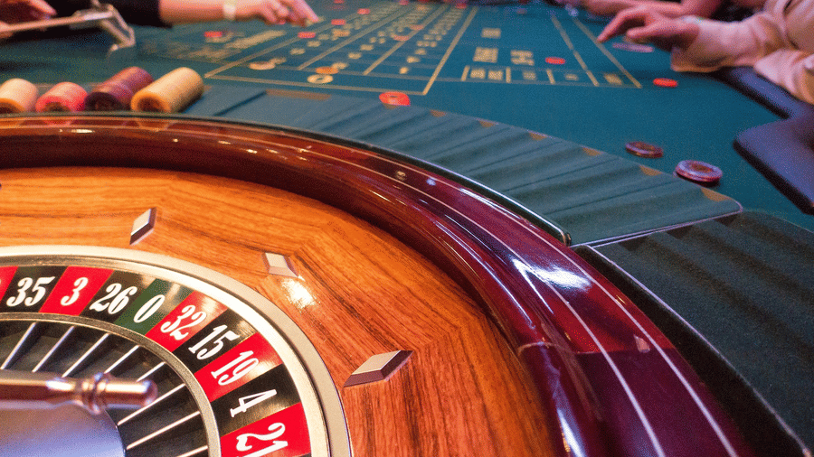 a close-up of a casino board with people dealing chips