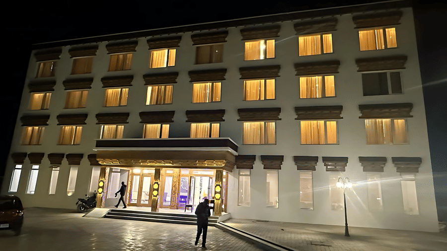 Night view of the illuminated multi-storey facade of Hotel Dekiling by Eastlynn Collections, Leh, with glowing windows and a bright entrance.