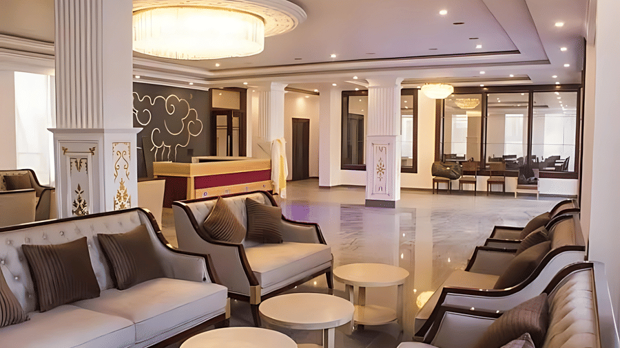 The main lobby of Hotel Dekiling by Eastlynn Collections, Leh showing a reception desk, plush seating arrangements, and a large circular ceiling light.
