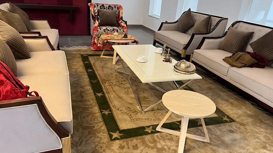 A spacious lounge area at Hotel Dekiling by Eastlynn Collections, Leh with neutral sofas, a coffee table, and a patterned rug.