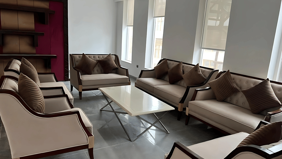 A bright lounge space at Hotel Dekiling by Eastlynn Collections, Leh, with neutral-toned sofas, cushions, and a coffee table.