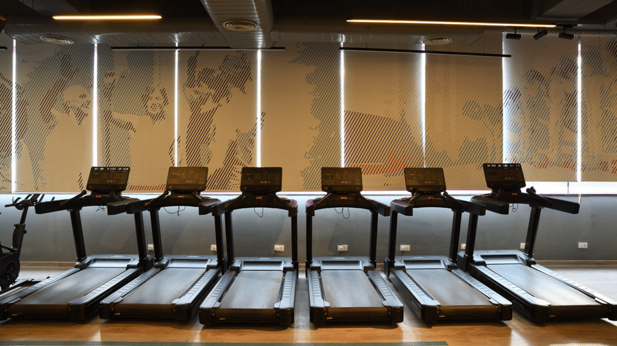 Cardio training area at a gym with treadmills arranged for indoor workouts | Ramada Encore by Wyndham Gurugram Dwarka Expressway