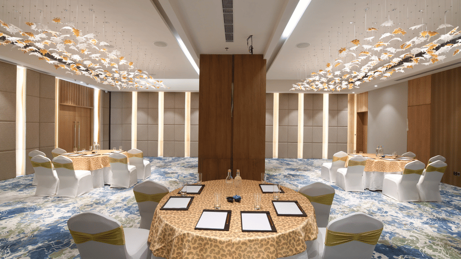Event hall featuring round table seating and flexible layout for conferences or functions | Ramada Encore by Wyndham Gurugram Dwarka Expressway