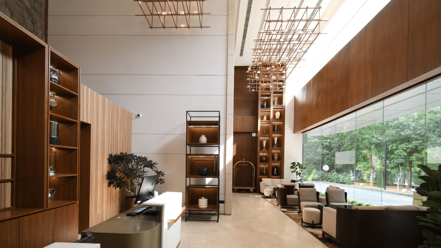 Spacious hotel lobby with modern seating, tall ceilings, and natural light from large windows | Ramada Encore by Wyndham Gurugram Dwarka Expressway