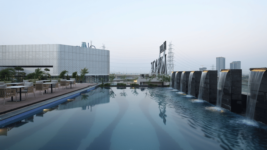 Infinity swimming pool overlooking the city with serene rooftop ambience | Ramada Encore by Wyndham Gurugram Dwarka Expressway