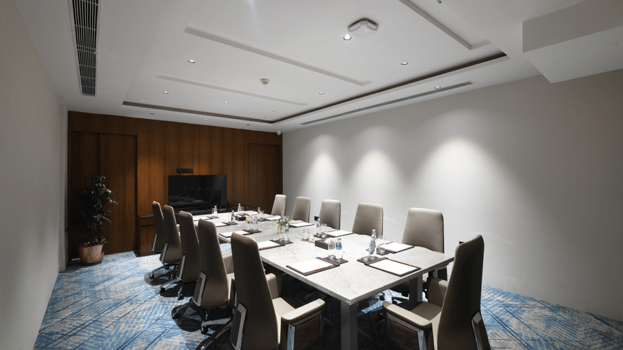 Private meeting room with formal boardroom seating and modern ceiling design | Ramada Encore by Wyndham Gurugram Dwarka Expressway