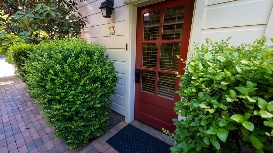 The Farmhouse Suite Entrance of Tallman Hotel bordered by the bushes.