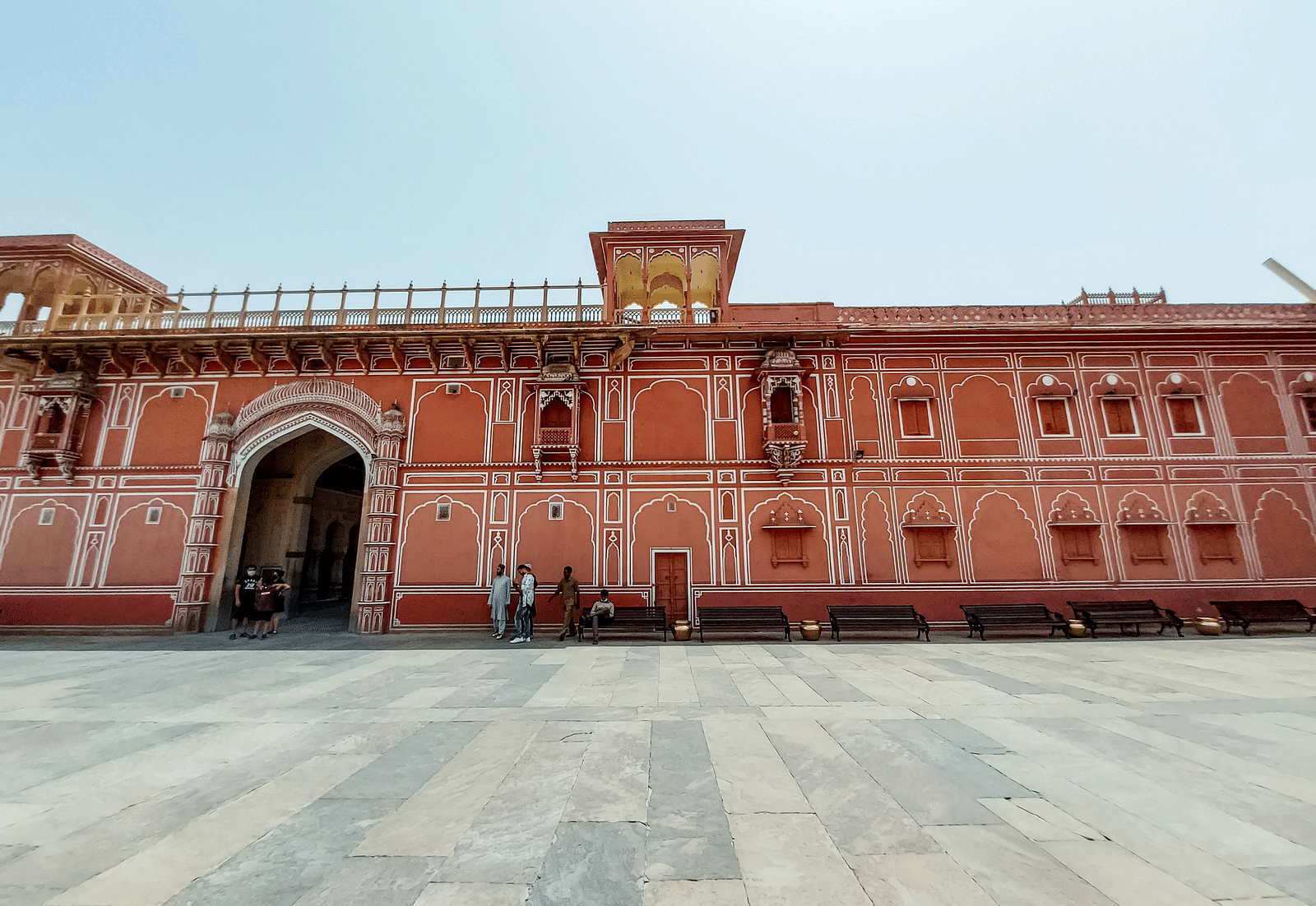 facade image of the city palace in jaipur with a clear backdrop of a light blue sky