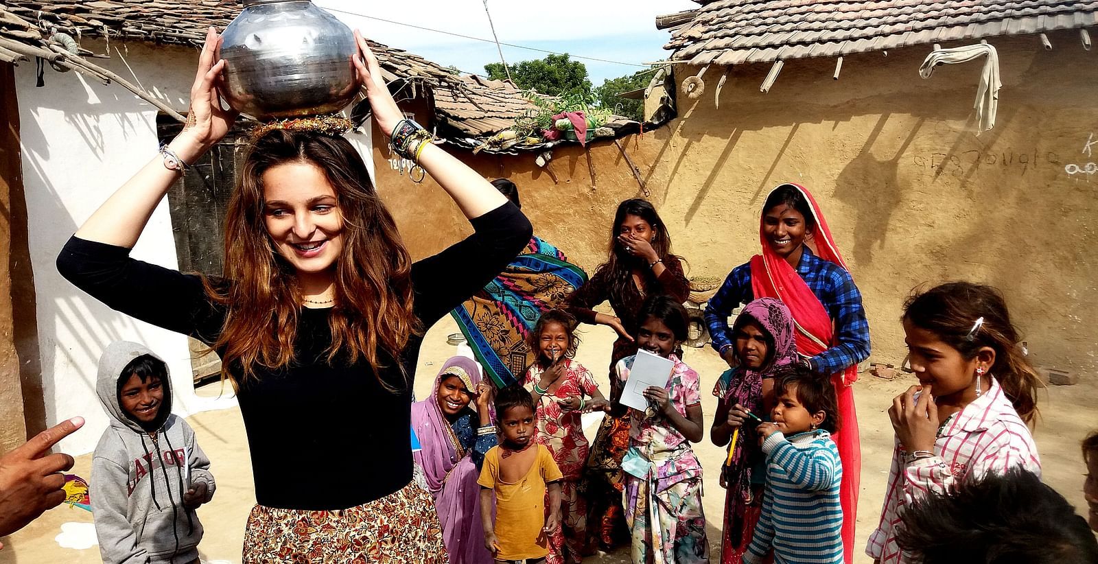 A group of people standing together one with a pot in her head- Shahpura Bagh.