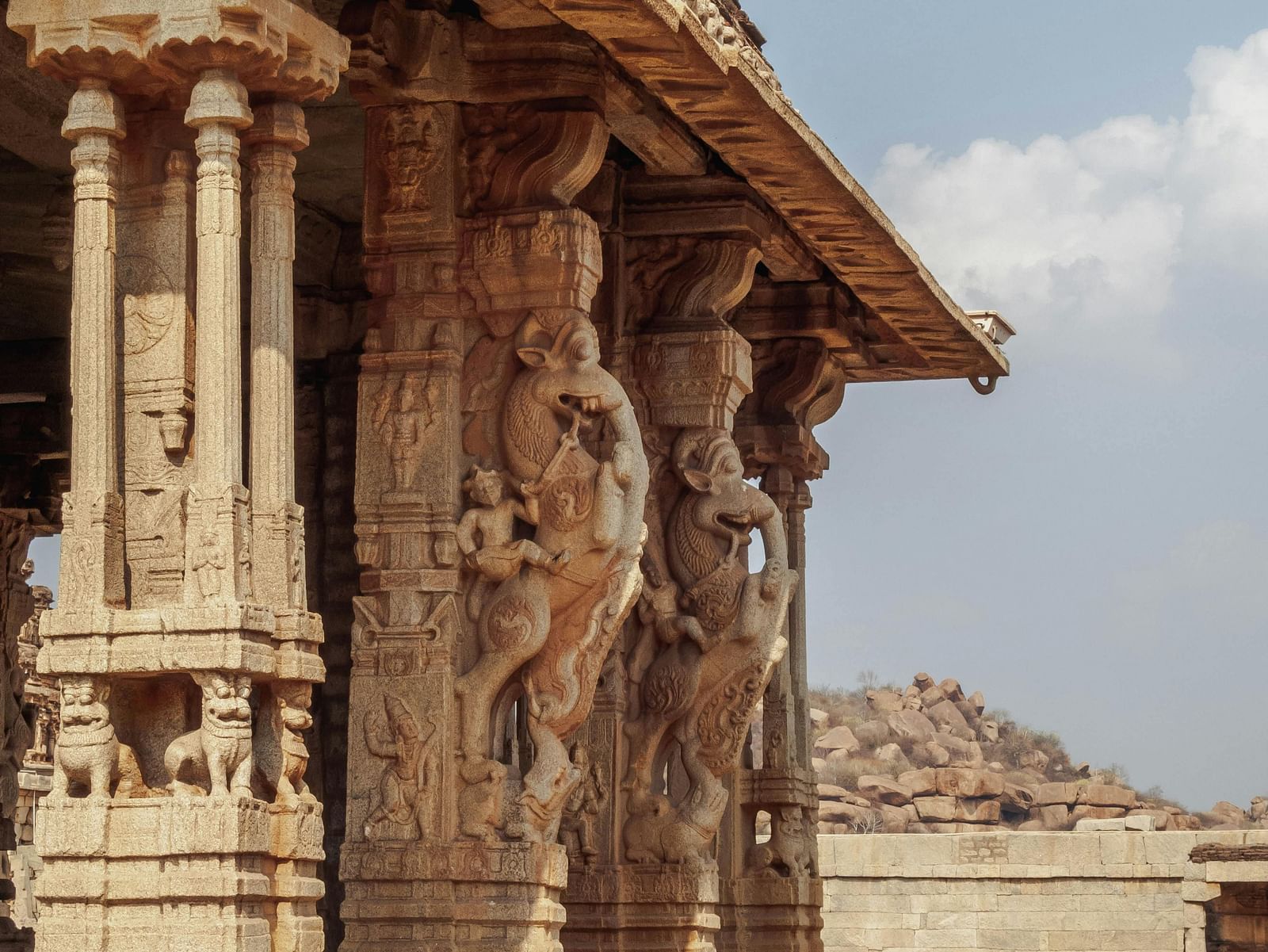 Temple pillars adorned with intricate sculptures.